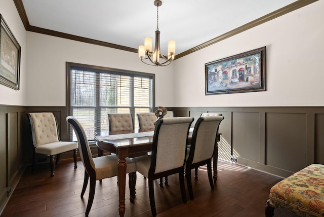 dining space featuring a notable chandelier, crown molding, and dark hardwood / wood-style floors