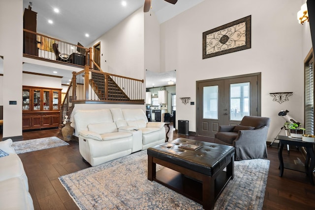 living room with french doors, dark wood-type flooring, and a high ceiling