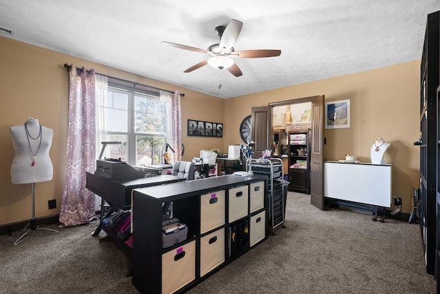 carpeted office featuring ceiling fan and a textured ceiling