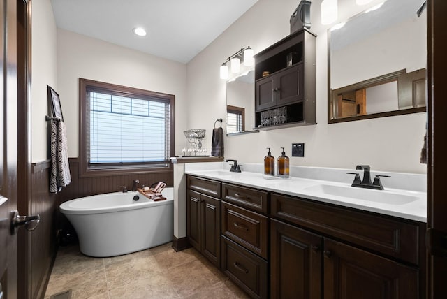 bathroom with vanity and a bathtub