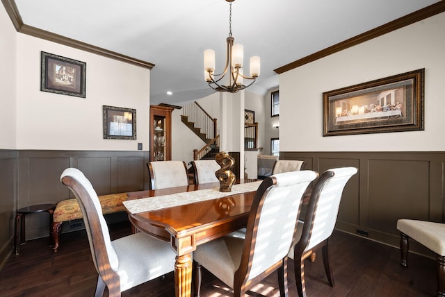 dining area with ornamental molding, dark hardwood / wood-style flooring, and a chandelier