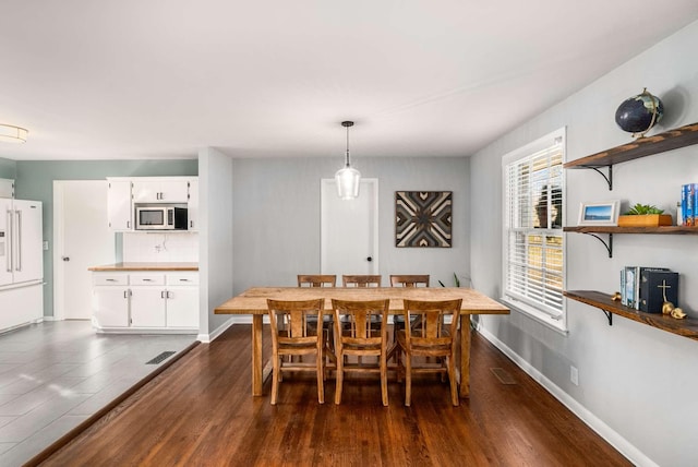 dining room with dark wood-type flooring