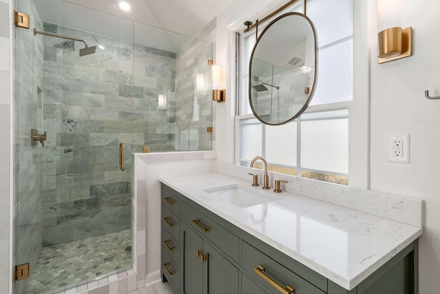 bathroom with vanity and a shower stall