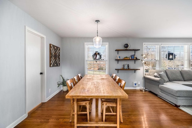 dining area with dark hardwood / wood-style flooring