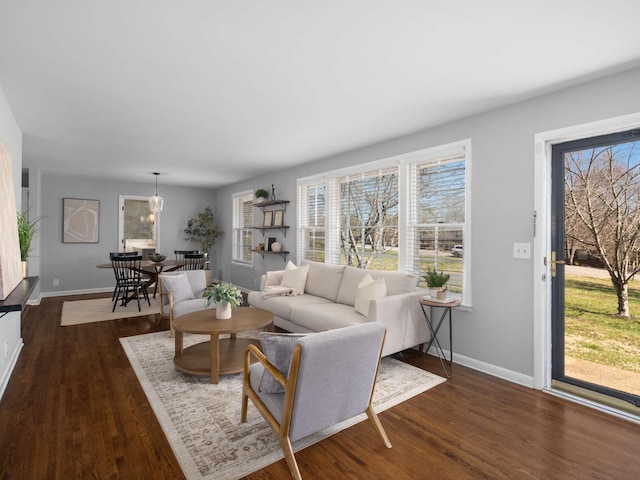 living room with dark wood finished floors and baseboards