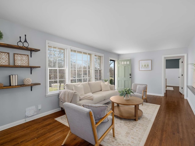 living room featuring dark wood finished floors, plenty of natural light, and baseboards