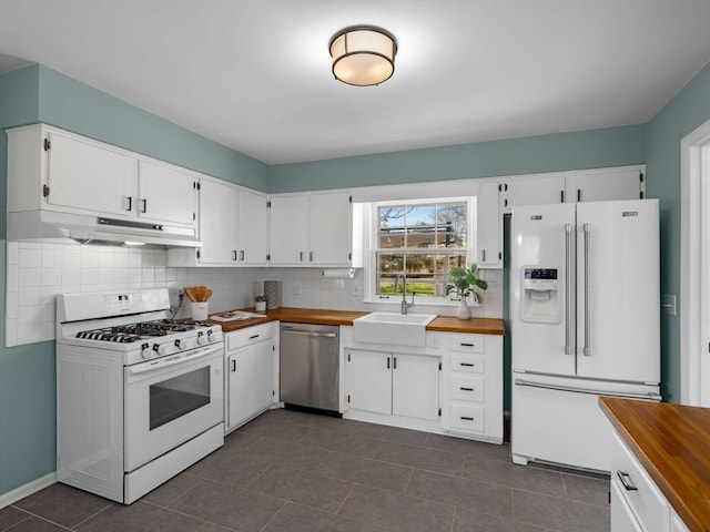 kitchen featuring wooden counters, white appliances, under cabinet range hood, and a sink