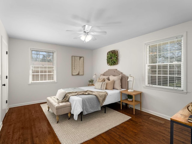 bedroom featuring a ceiling fan, dark wood-style floors, and baseboards