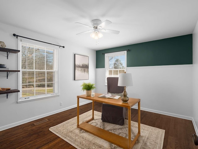 office space featuring visible vents, baseboards, wood finished floors, and a ceiling fan