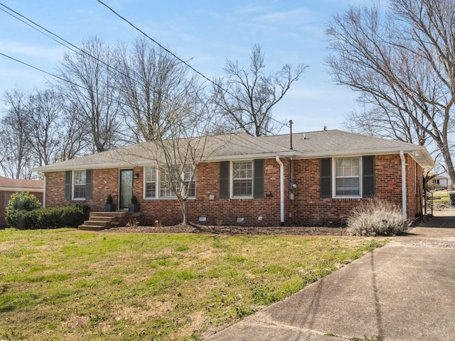 ranch-style house with brick siding, crawl space, a front lawn, and roof with shingles