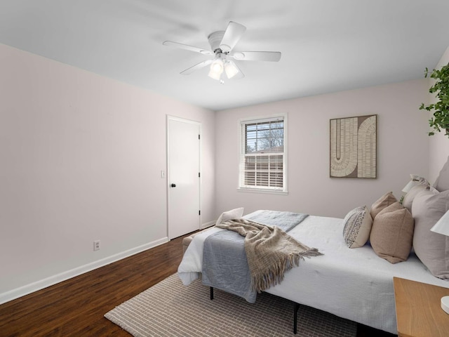 bedroom featuring ceiling fan, baseboards, and wood finished floors