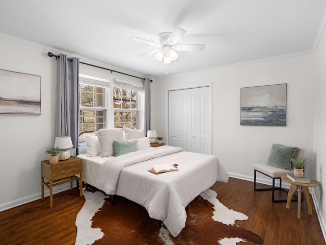 bedroom featuring ornamental molding, wood finished floors, a closet, and baseboards