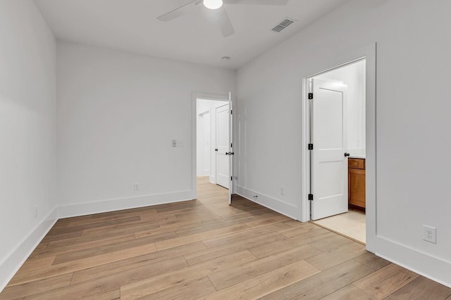 empty room featuring ceiling fan and light hardwood / wood-style flooring