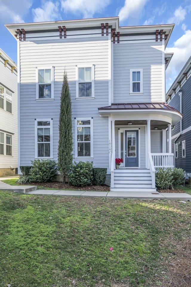 view of front of house with a porch and a front yard