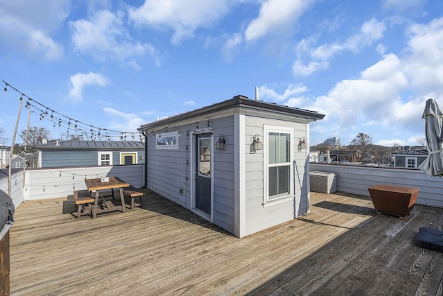 wooden deck featuring an outbuilding