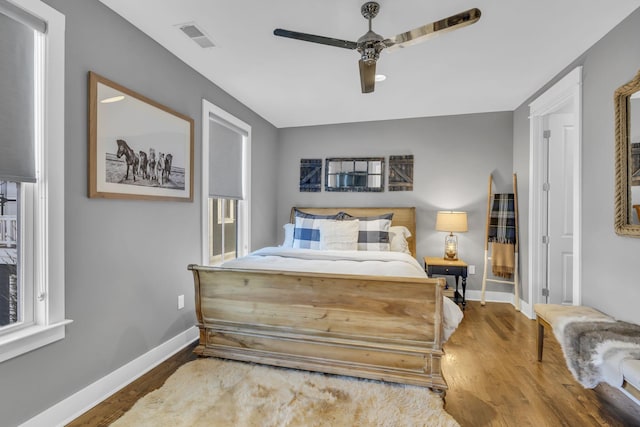 bedroom with hardwood / wood-style floors and ceiling fan