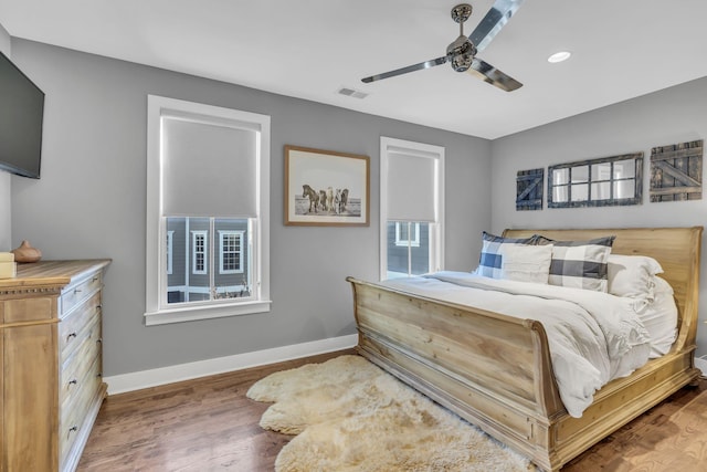 bedroom with hardwood / wood-style flooring and ceiling fan