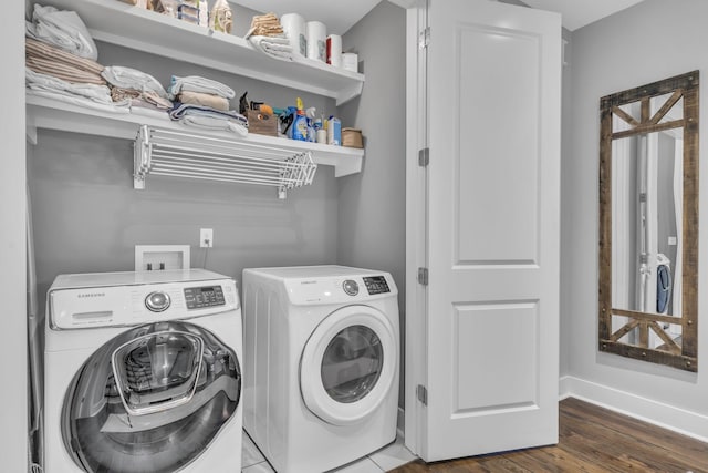 washroom featuring wood-type flooring and washer and clothes dryer