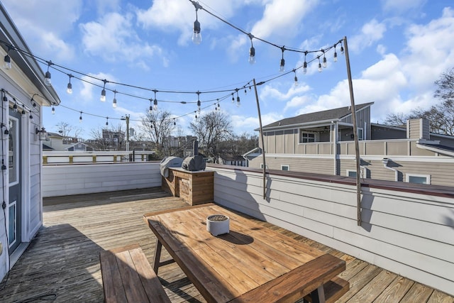 wooden terrace with a grill