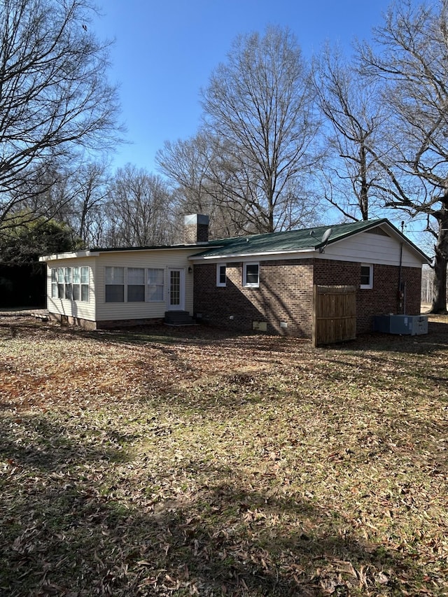 rear view of property featuring cooling unit