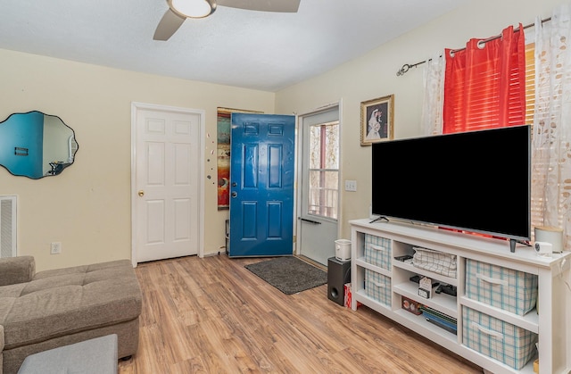 living room featuring hardwood / wood-style flooring and ceiling fan