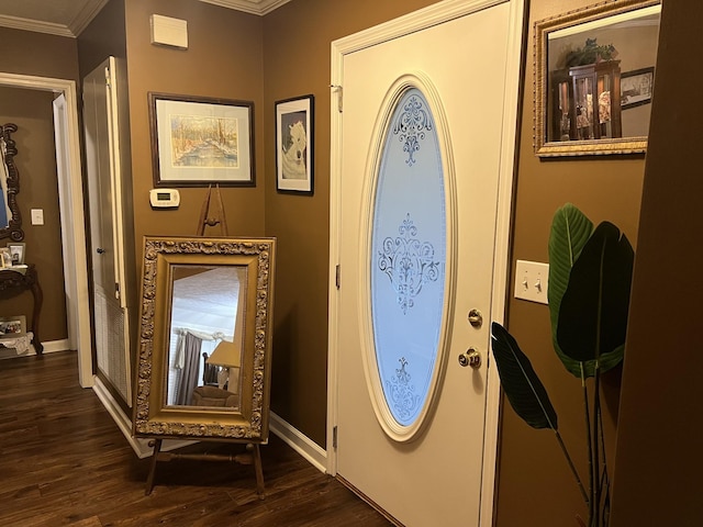 foyer with dark hardwood / wood-style flooring and ornamental molding