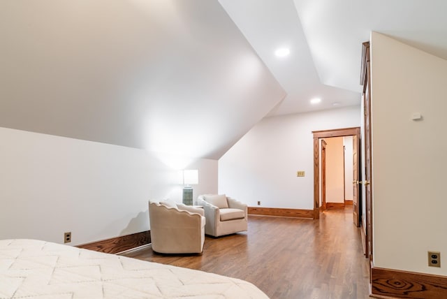 bedroom with lofted ceiling and wood-type flooring