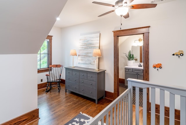 bedroom with sink, dark wood-type flooring, ceiling fan, and vaulted ceiling