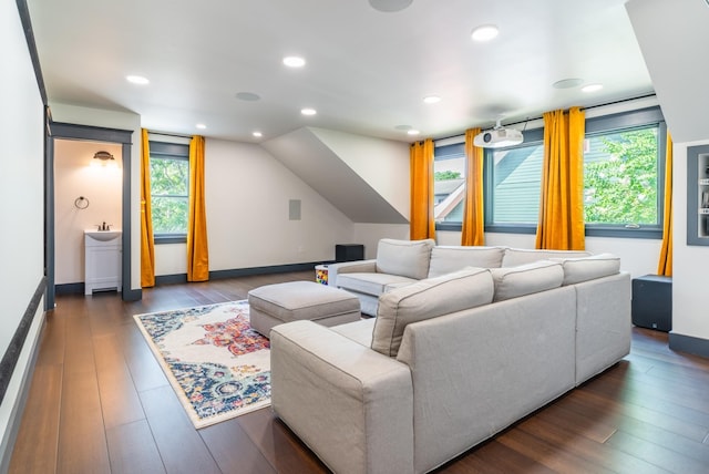 living room with lofted ceiling, dark wood-type flooring, and sink