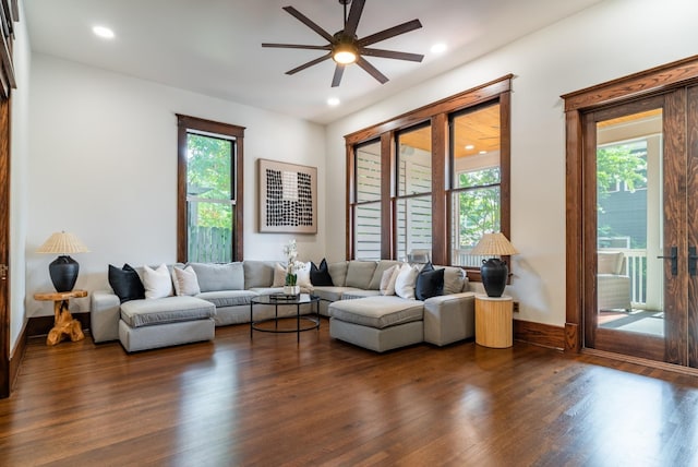 living room featuring dark hardwood / wood-style flooring and ceiling fan