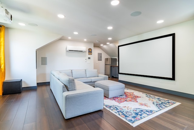 home theater room featuring vaulted ceiling, an AC wall unit, electric panel, and dark hardwood / wood-style flooring