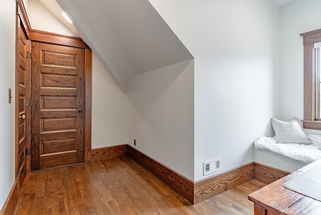 additional living space featuring hardwood / wood-style flooring and lofted ceiling