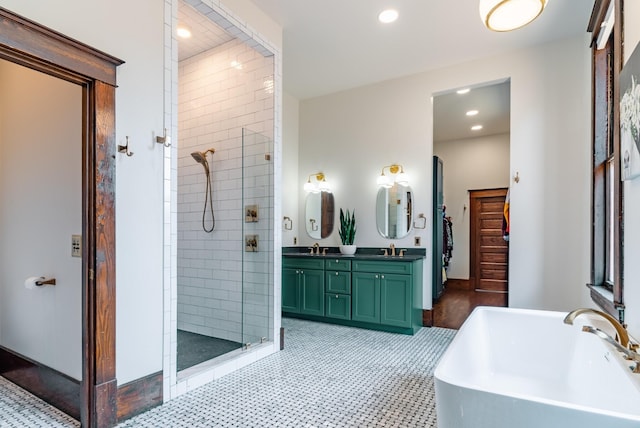 bathroom with vanity and separate shower and tub