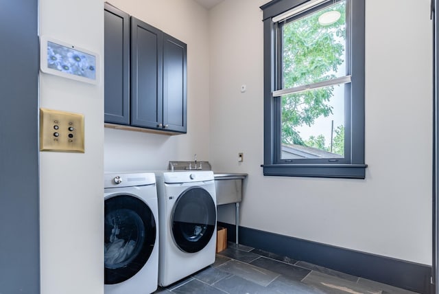 washroom with cabinets and washer and clothes dryer