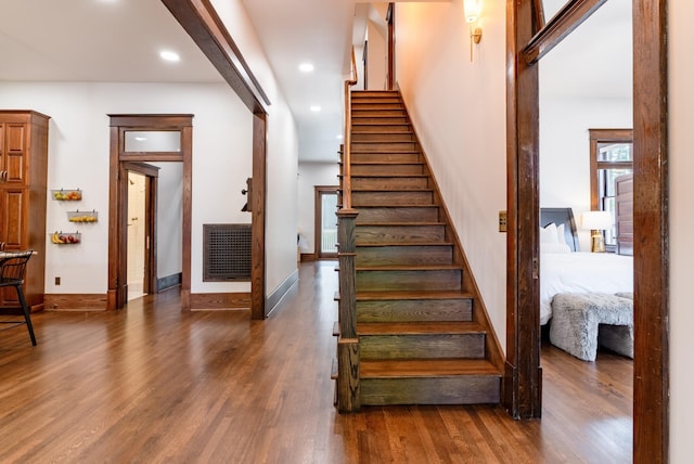 stairs featuring hardwood / wood-style floors