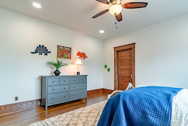 bedroom with hardwood / wood-style floors and ceiling fan