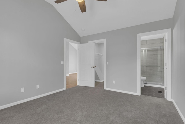 unfurnished bedroom featuring carpet floors, a walk in closet, ceiling fan, ensuite bath, and a closet