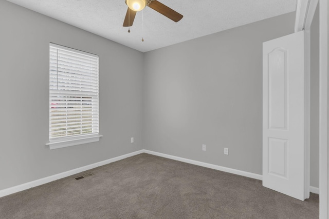 spare room with ceiling fan, carpet flooring, and a textured ceiling