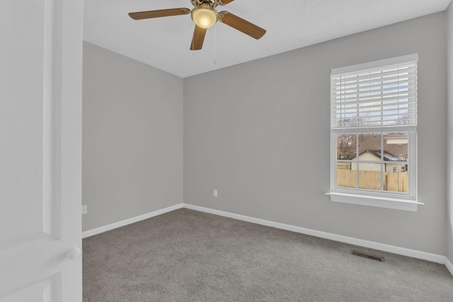 empty room featuring carpet floors and ceiling fan