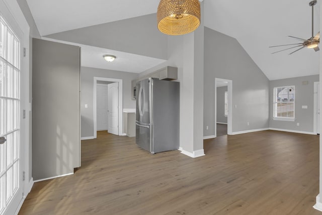 unfurnished living room featuring lofted ceiling, hardwood / wood-style flooring, and ceiling fan