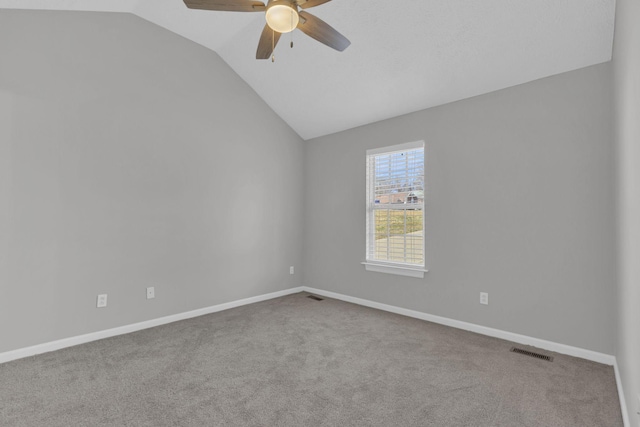 unfurnished room featuring ceiling fan, vaulted ceiling, and light carpet