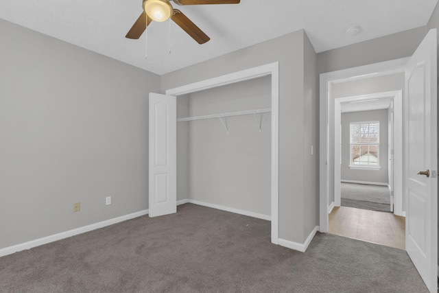 unfurnished bedroom featuring carpet floors, ceiling fan, and a closet