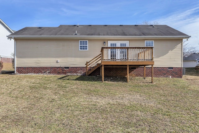 rear view of house featuring a wooden deck and a lawn