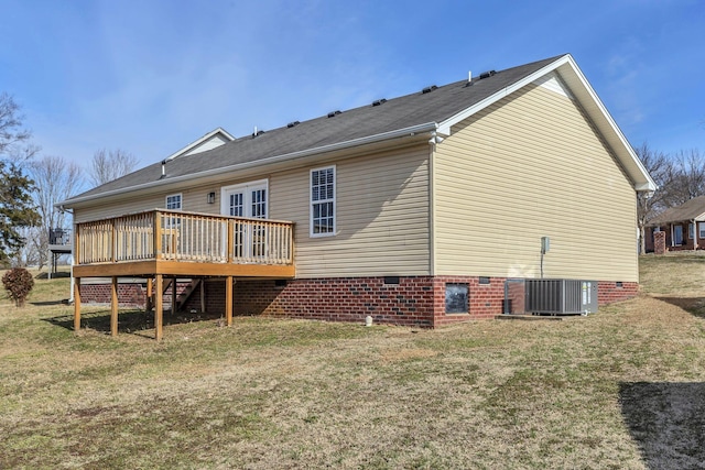 back of house featuring central AC, a deck, and a lawn