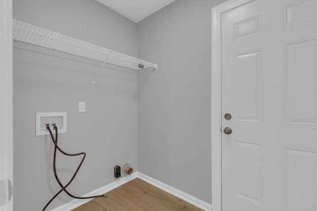 washroom with washer hookup and hardwood / wood-style flooring