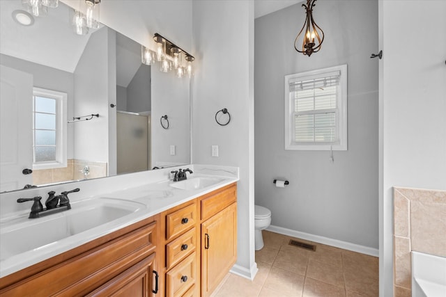 bathroom with vaulted ceiling, vanity, a shower with shower door, tile patterned floors, and toilet