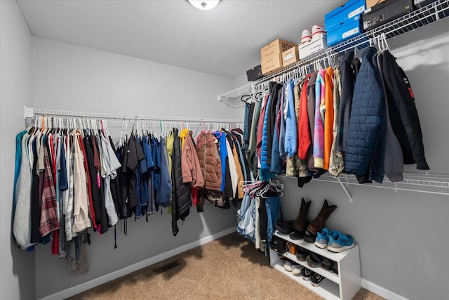 walk in closet featuring carpet