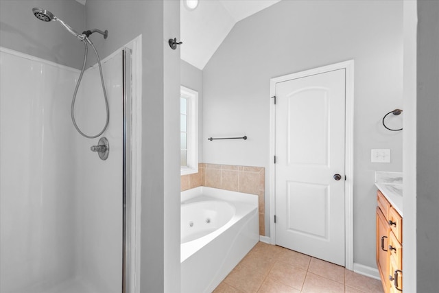 bathroom with lofted ceiling, independent shower and bath, tile patterned flooring, and vanity