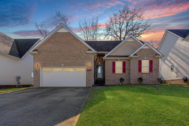 view of front of home featuring a garage and a lawn