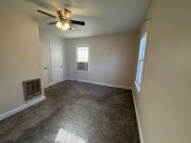 carpeted spare room with heating unit, cooling unit, and ceiling fan